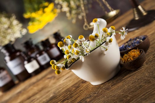 Natural medicine, herbs, mortar on wooden table background