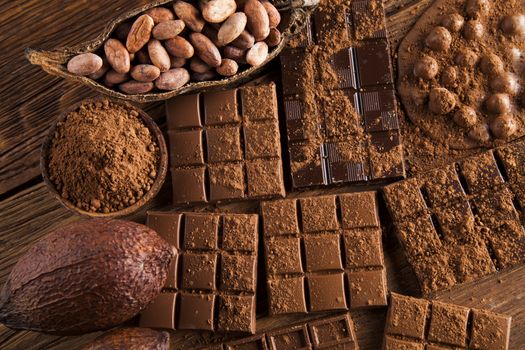 Milk and dark chocolate on a wooden table