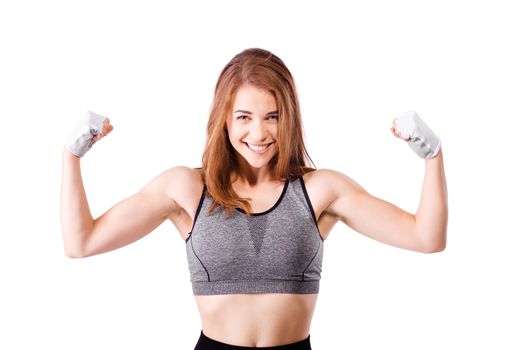athletic girl showing her muscles and smiling