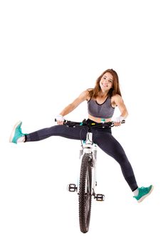 girl posing on a mountainbike against white background