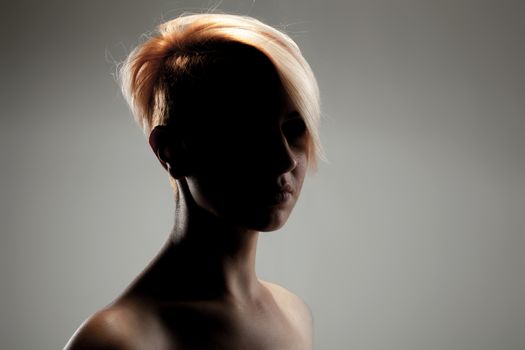 silhouette portrait of a beautiful caucasian girl with short hair