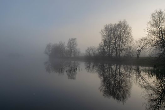 Foggy morning and calm lake