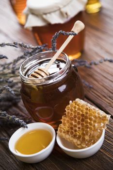 Jar full of fresh honey and honeycombs