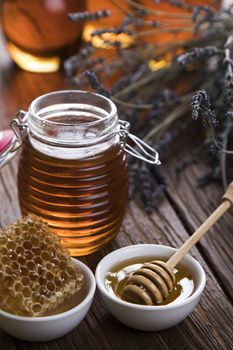 Jar of honey with honeycomb