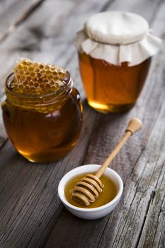 Jar full of fresh honey and honeycombs