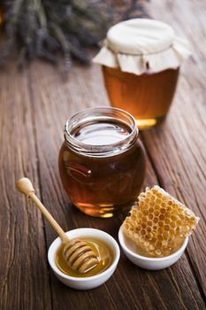 Jar full of fresh honey and honeycombs