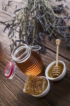 Jar full of fresh honey and honeycombs