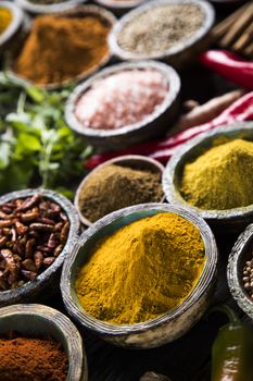 Spices and herbs in wooden bowls. Food and cuisine ingredients