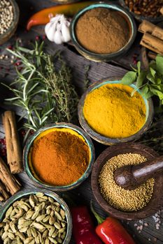 Variety of spices and herbs on kitchen table