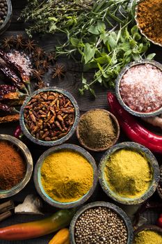 Spices and herbs in wooden bowls. Food and cuisine ingredients