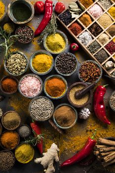 Variety of wooden box, spices and herbs on kitchen table