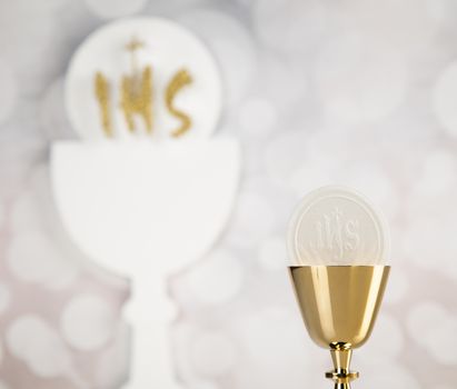 Holy communion a golden chalice, composition isolated on white