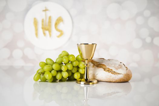 Holy communion a golden chalice, composition isolated on white