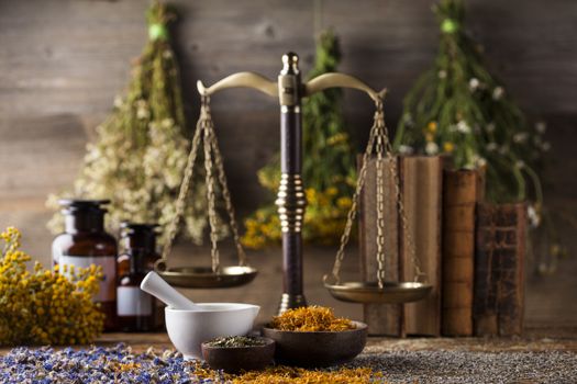 Herbs medicine,Natural remedy and mortar on vintage wooden desk background