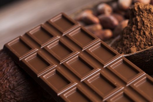 Aromatic cocoa and chocolate on wooden background