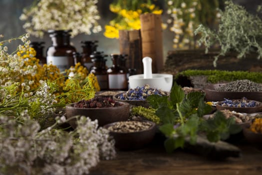 Natural medicine, herbs, mortar on wooden table background