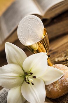 Holy communion a golden chalice with grapes and bread wafers