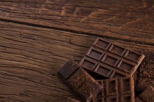 Dark and milk chocolate bar on a wooden table