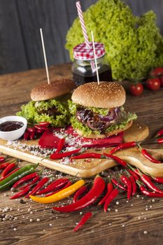 Close-up of home made burgers, wooden desk background