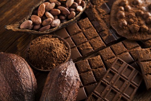 Milk and dark chocolate on a wooden table