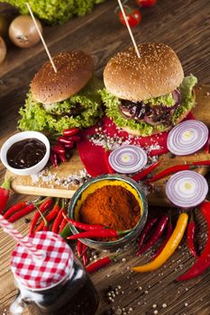 Close-up of home made burgers, wooden desk background