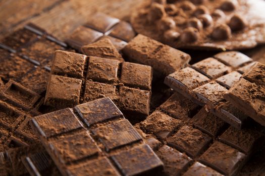 Dark and milk chocolate bar on a wooden table