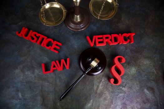 Law theme, mallet of the judge, justice scale, wooden desk background