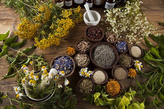 Natural medicine, herbs, mortar on wooden table background