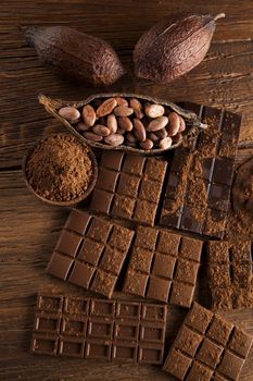 Aromatic cocoa and chocolate on wooden background