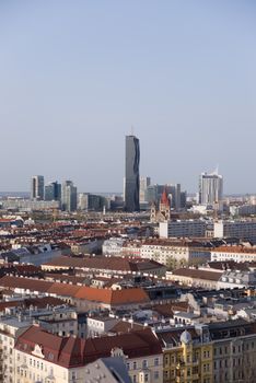 View over Vienna with skyline of Donau - Danube city centre in background, roofs of old town of Vienna in front