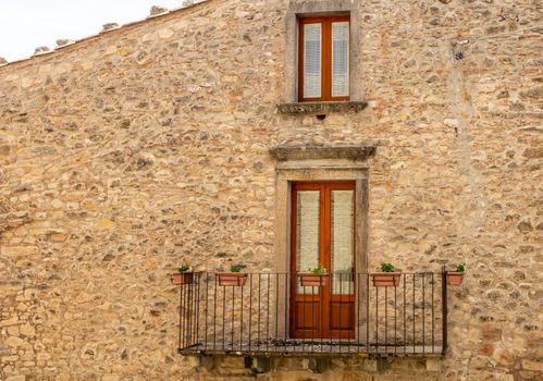 The window and the balcony of an ancient Sicilian medieval house