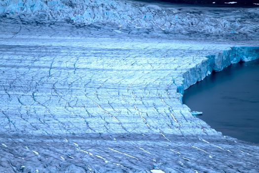 Harsh glaciers of Arctic. Live glacier: Front wall and glacial grotto. Novaya Zemlya archipelago, North island. View from helicopter