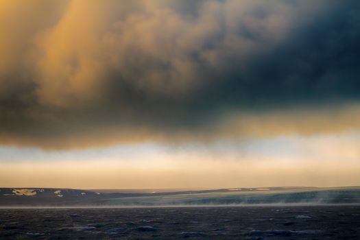 Hurricane (Bora) in Arctic Kara sea on Novaya Zemlya archipelago. Cold wind flows down from glacier with great speed (58 meters per second)