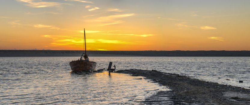 Old abandoned boat at sunset. Drying salt lake near Odessa, Ukraine