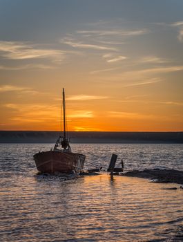 Old abandoned boat at sunset. Drying salt lake near Odessa, Ukraine