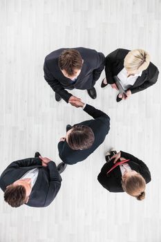 Business people shaking hands, finishing up a meeting, top view