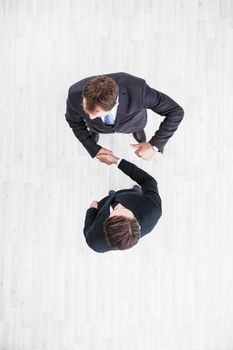 Business men shaking hands, finishing up a meeting, top view with copy space