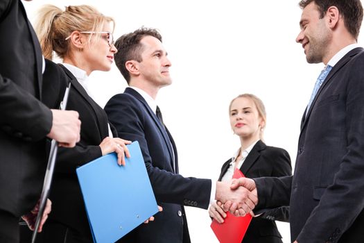 Business people shaking hands, finishing up a meeting, isolated on white background