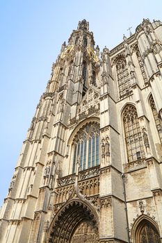 Medieval gothic cathedral of Our Lady in Antwerp, Belgium over clear blue sky, low angle front view