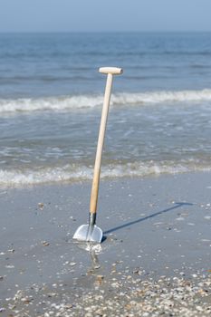 Shovel in the sand from the North Sea Beach
