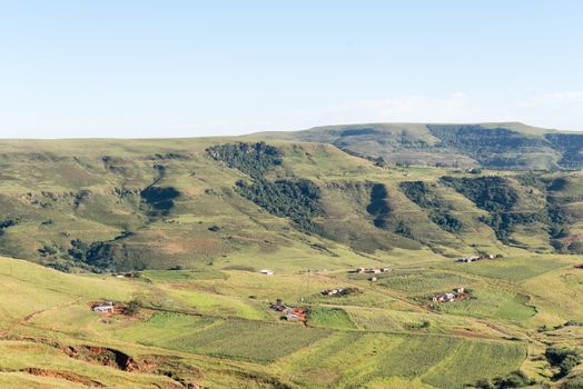 An aerial view of farms on the road to Injisuthi in the Kwazulu-Natal Drakensberg. Houses and corn fields are visible