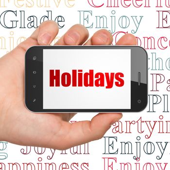 Holiday concept: Hand Holding Smartphone with  red text Holidays on display,  Tag Cloud background, 3D rendering