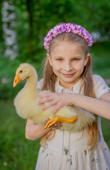 Closeup portrait girl with duckling holding