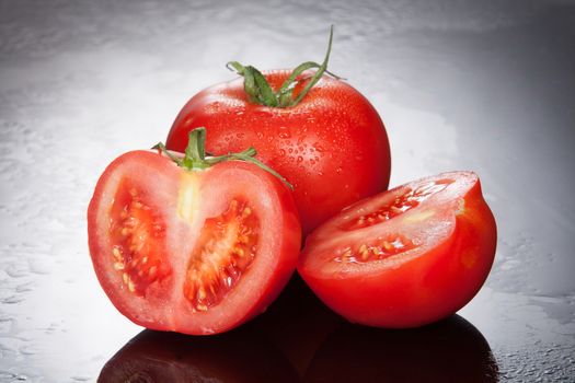 Tomatoes on a glass studio background
