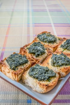 fresh homemade bread with cheese and spinach on plate