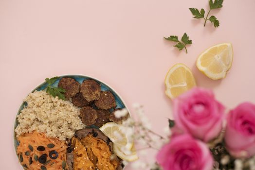 Healthy food concept. Clean eating. Meal with turkey meatballs, bulgur, sweet potato, carrot, salad. Pink and gold concept. Low carb eating, light lunch, fitness menu