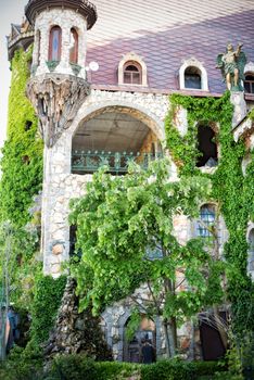 Beautiful old fairy-tale castle near Burgas, Bulgaria. Walls of the castle, green flower garden 