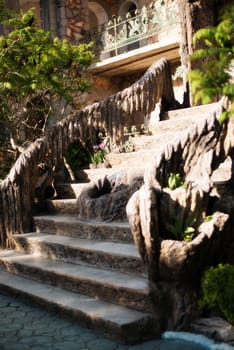 Old baroque stairs, outdoors. Stairs made of stone, small fountain with running water in the middle