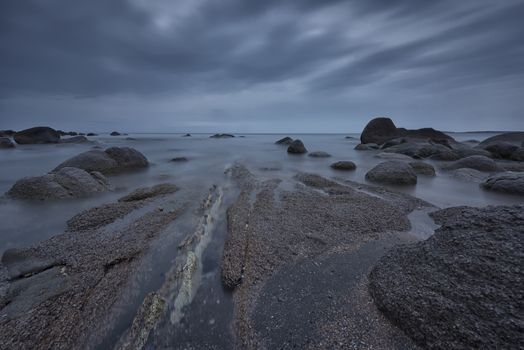 Seascape before sunrise in cloudy morning. Beautiful natural seascape, blue hour. Rocky sunrise. Sea sunrise at the Black Sea coast near Atia, Chernomoretz