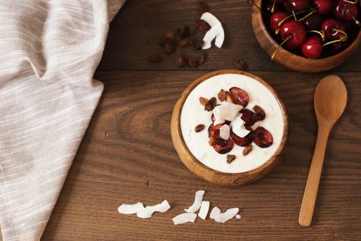 Oat Flakes With Yogurt And Fruits. Cherries, Raisins And Coconut Chips. Overnight Breakfast. Healthy Food Concept. Fitness Mood Diet. Summer Light Snack. Dark Wooden Background